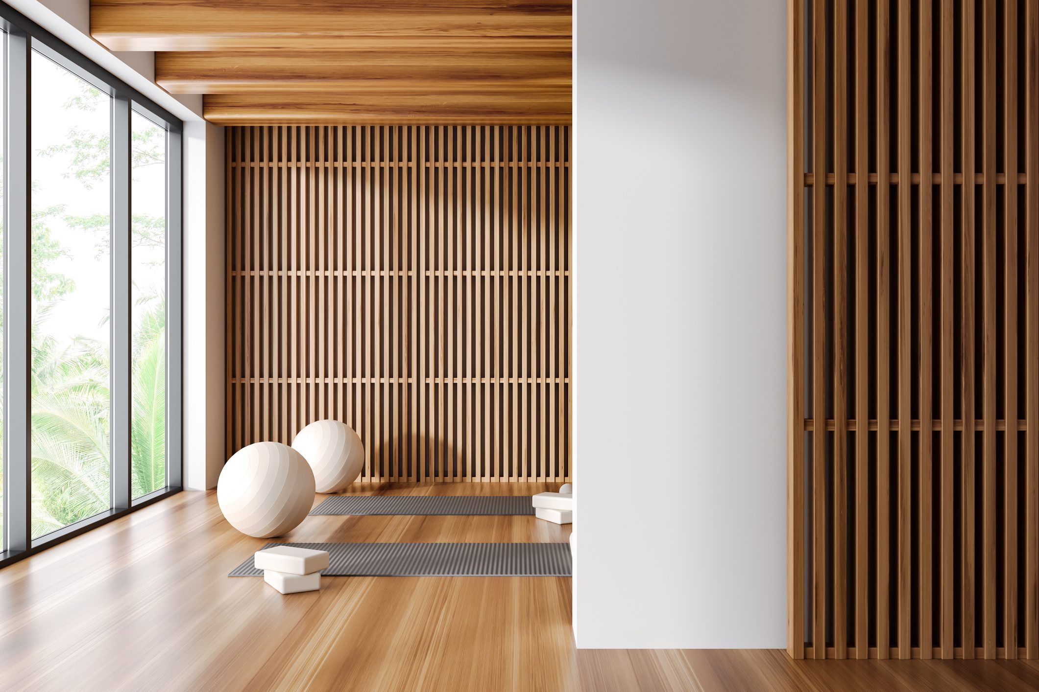 Minimalist room with wooden slats and spherical decor on wooden floor.